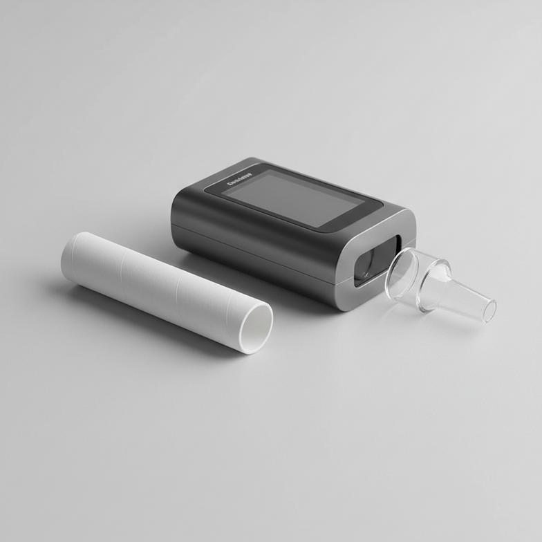 a paper tube breathalyzer mouthpiece next to a breathalyzer device