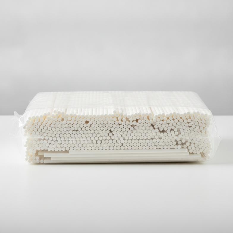 A large, clear polybag filled with hundreds of unwrapped paper straws, ready for bulk distribution.