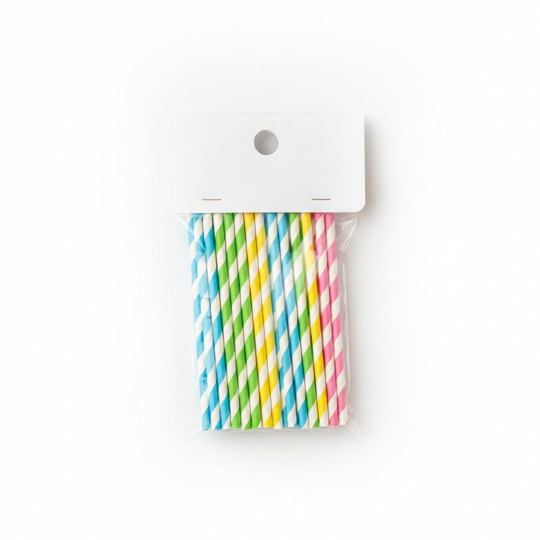 A clear polybag of colorful paper straws with a branded cardboard header card stapled to the top, ready for hanging on a retail display.
