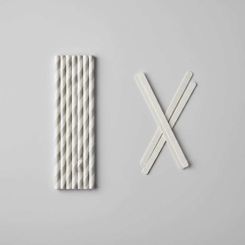 A close-up of paper straws and coffee stirrers side-by-side