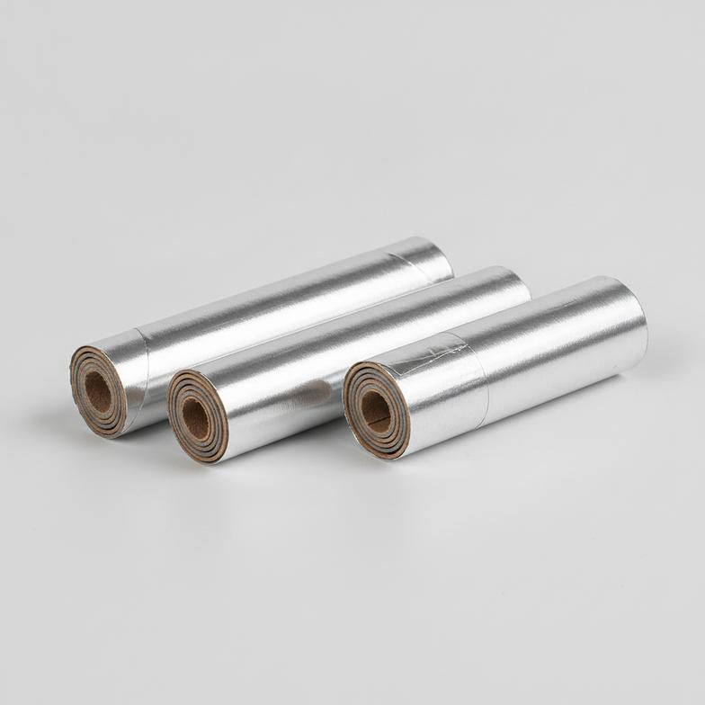 A detailed closeup of foil wrapped firework paper tubes showing the paper layers and foil finish.