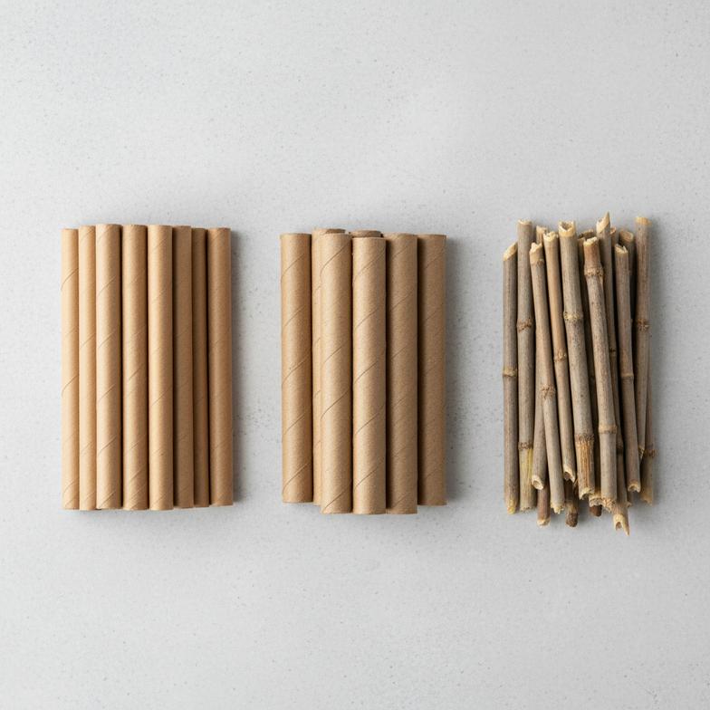 An assortment of different bee tube refill materials like paper, cardboard, and reeds.