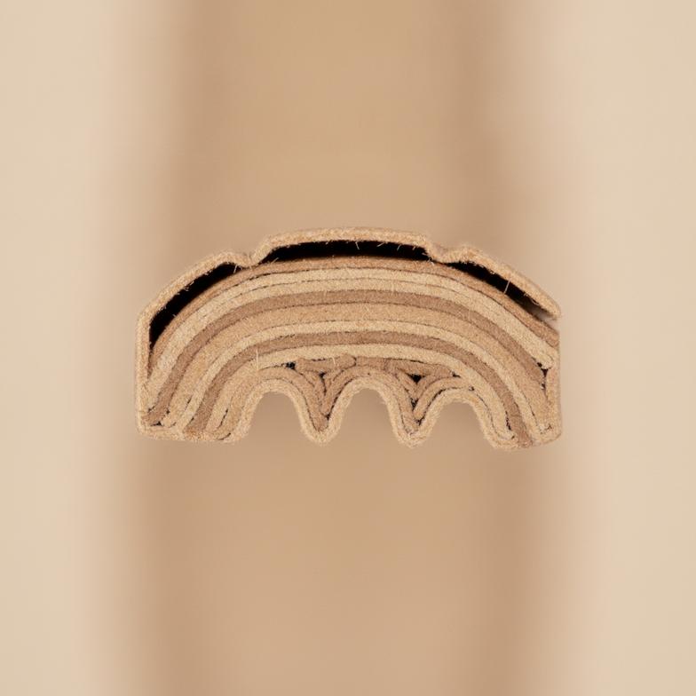 Cross-section view showing the multiple layers of an engineered paper cutlery fork.