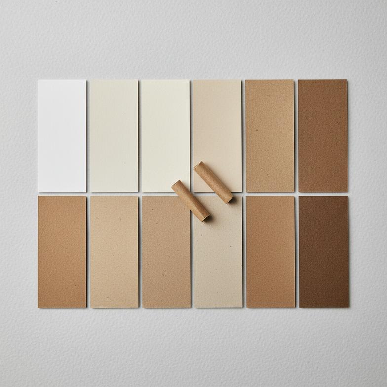 A close-up of various paper samples for hemp filter tips in different shades and textures