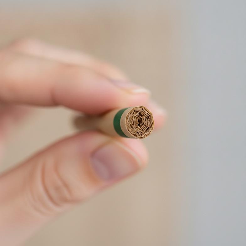 Someone holding a finished pre-roll, with the custom filter tip clearly visible and looking high-quality