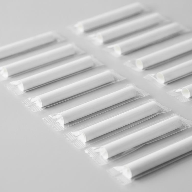 A collection of individually wrapped paper mouthpiece tubes for an alcohol testing program, showcasing their clean and professional appearance.