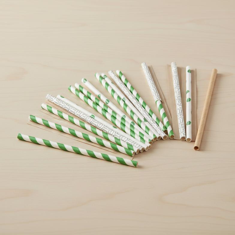 A collection of custom-printed paper straw wrappers with different logos and designs.